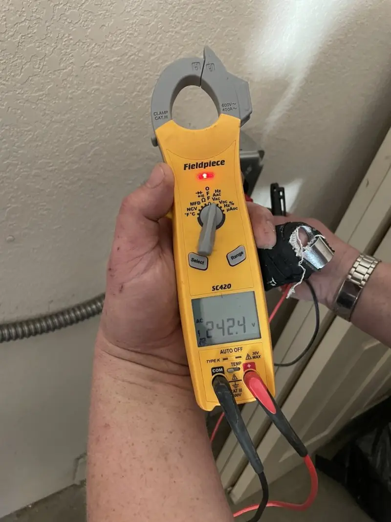 Voltage testing with clamp meter during Ceiling Fan Installation in Oronoko